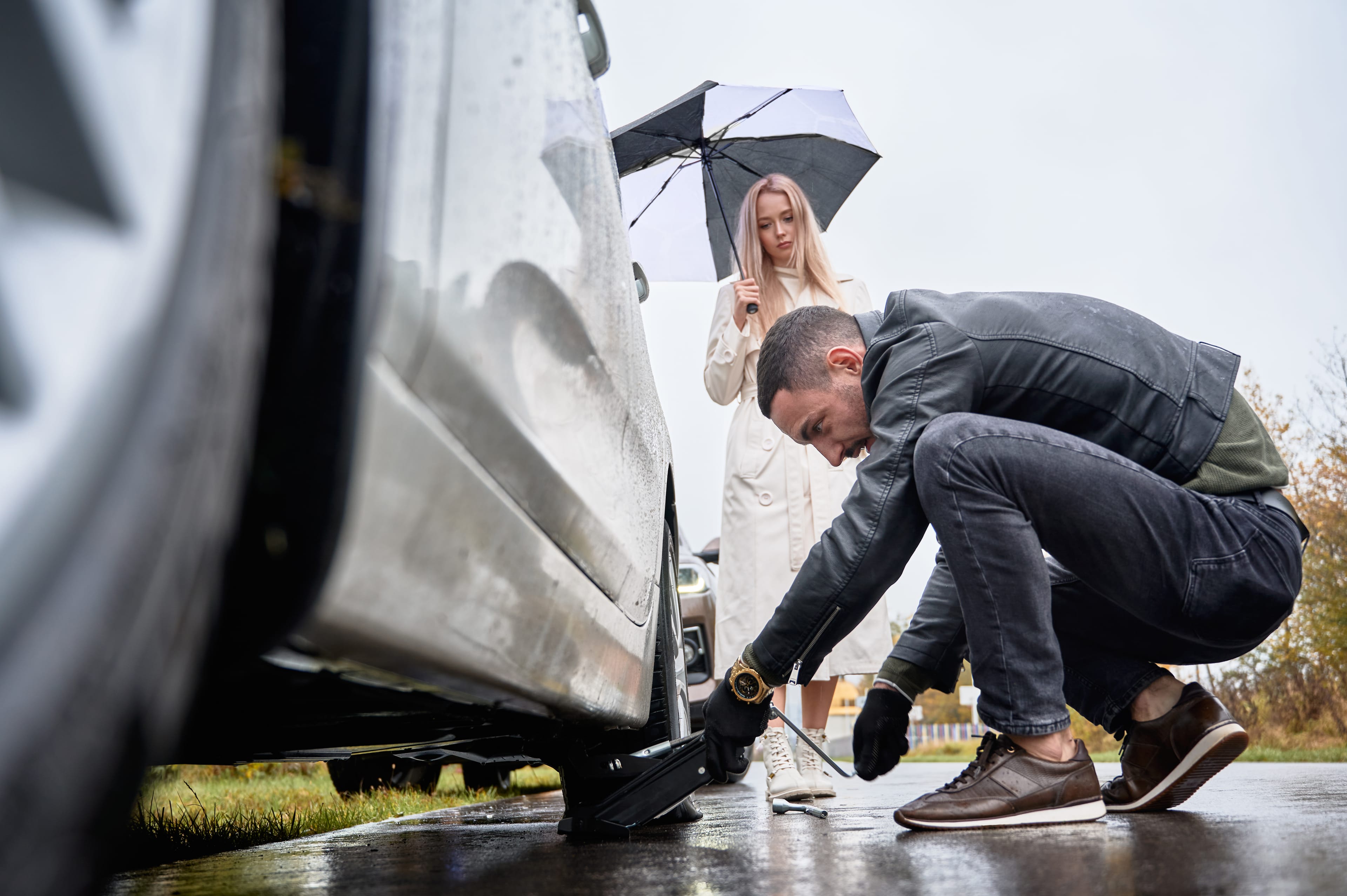 Mechanic delivering fuel to a stranded vehicle on the roadside