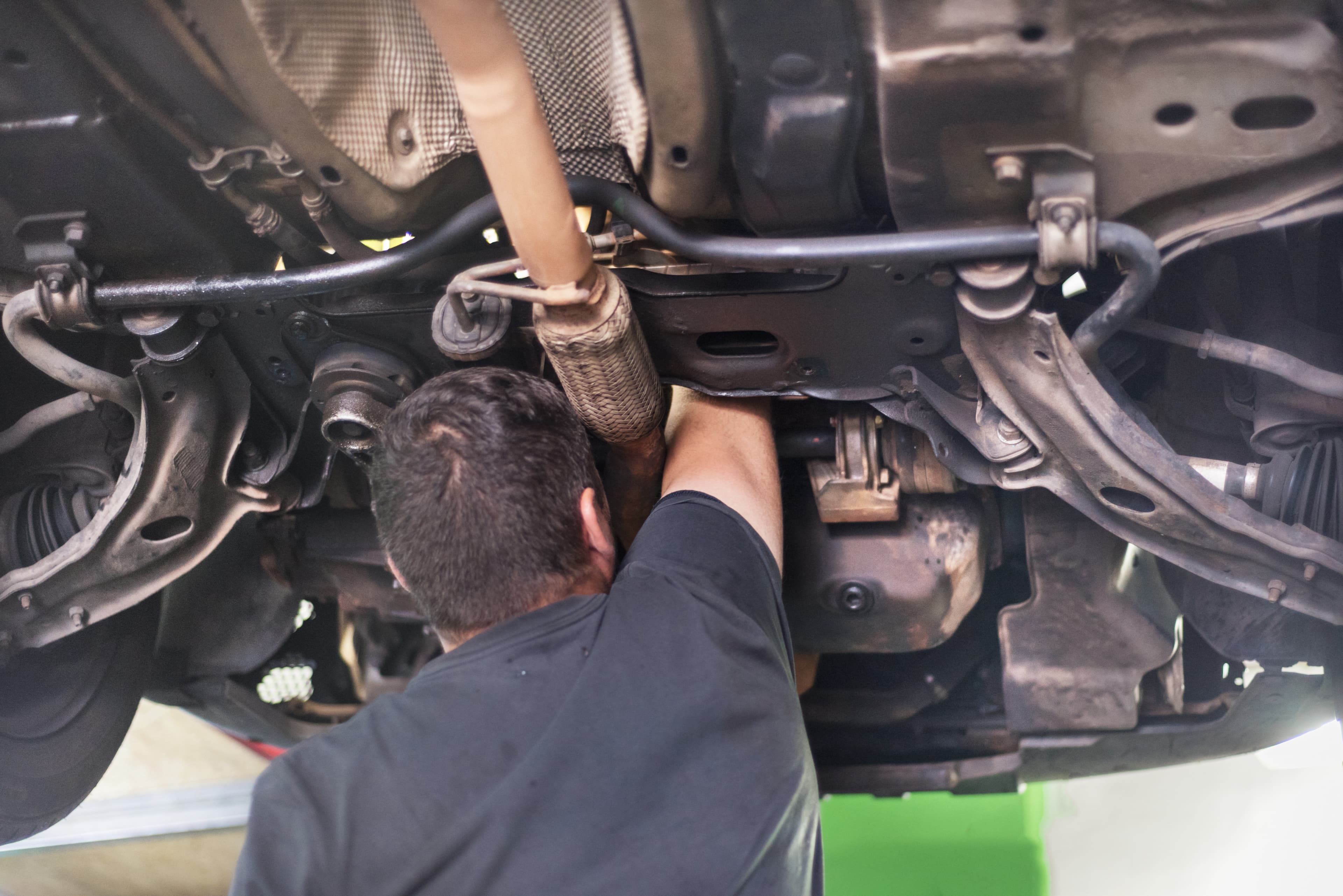 Mechanic tightening a suspension control arm